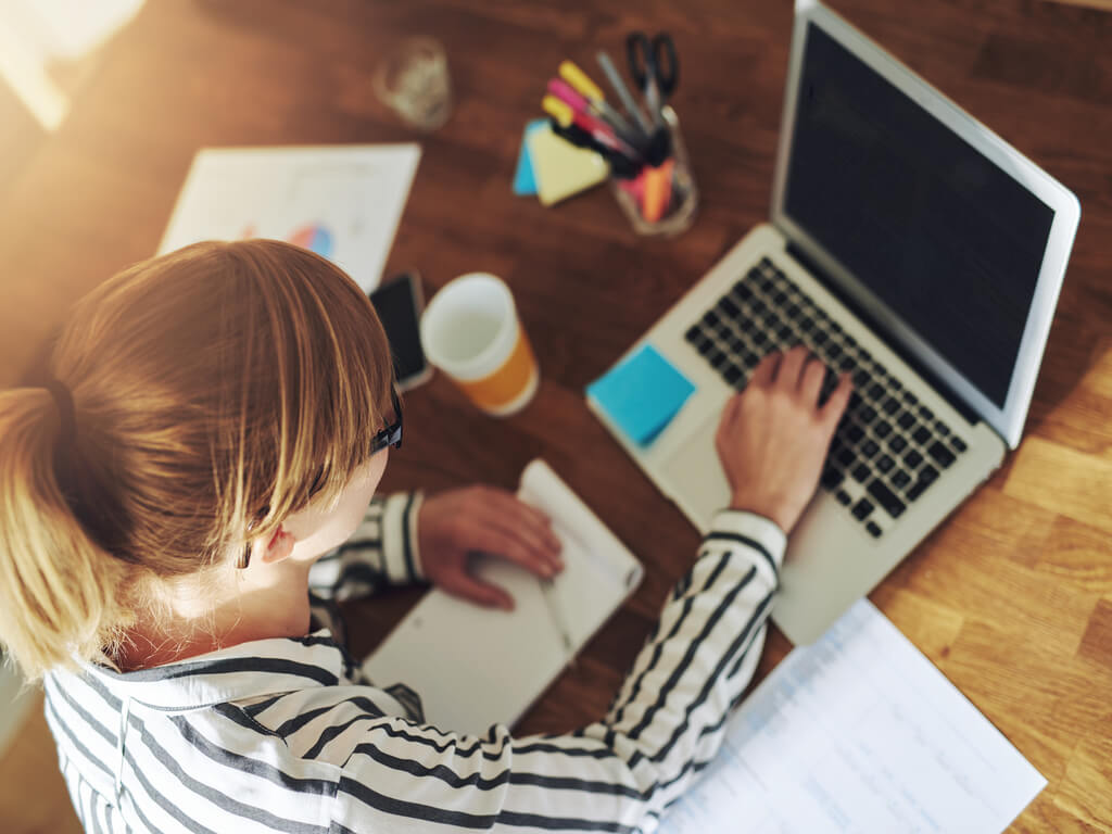 Woman entrepreneur working on laptop